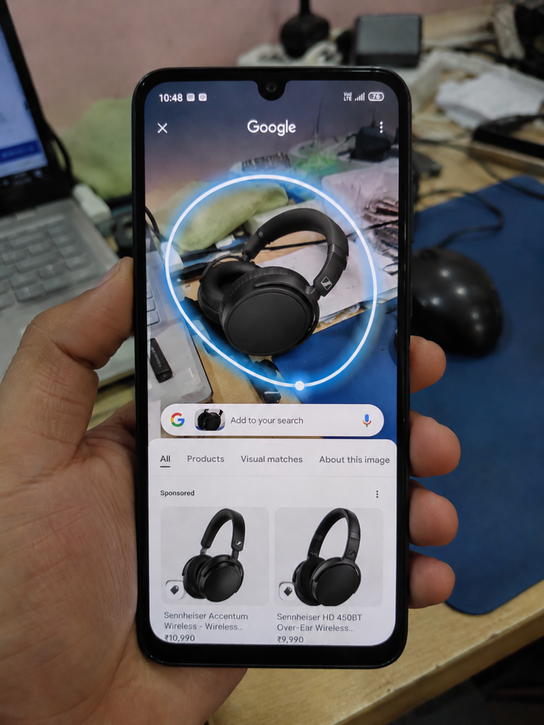Circle to Search AI feature on Samsung Galaxy A26 budget smartphone showing glowing blue circle around headphones on screen